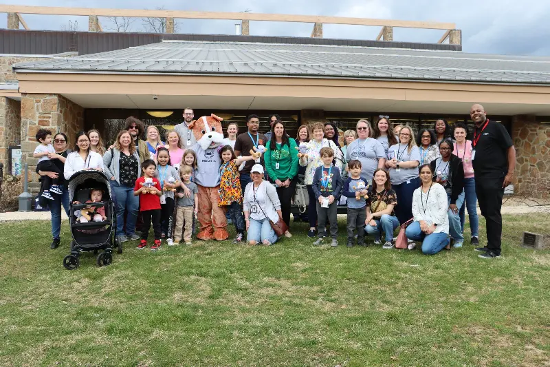 A group of Insight PA families and staff are gathered together at a community event.