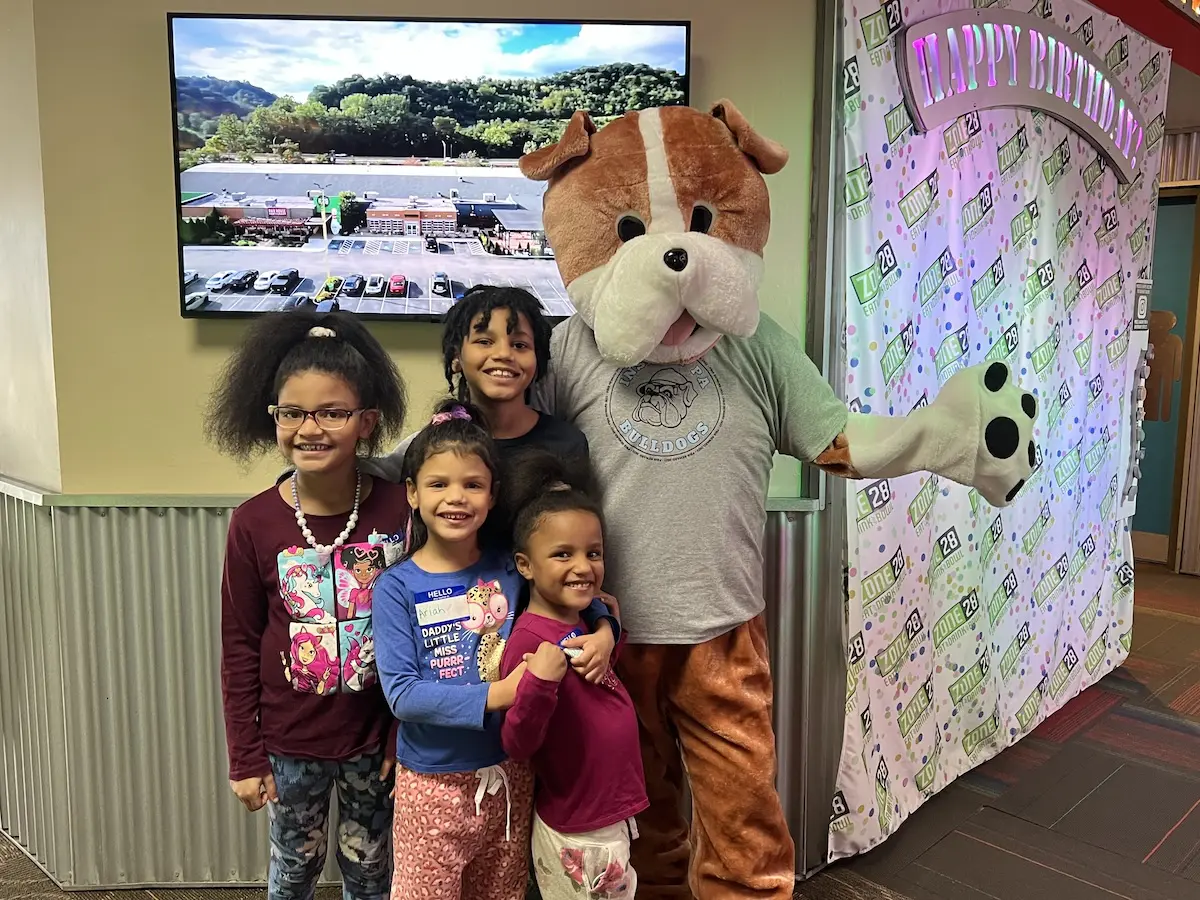 students pose with mascot Barkley