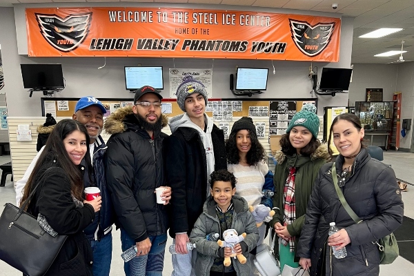 Insight PA students and families are gathered at an ice skating rink.