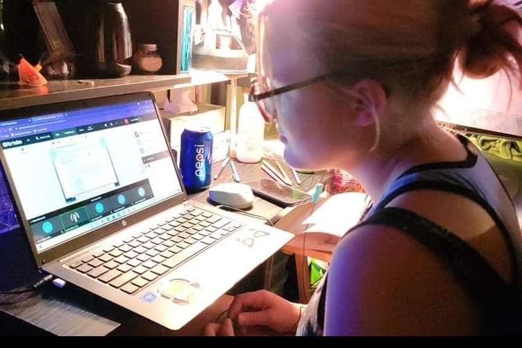 An Insight PA student is at their desk during a synchronous class session.